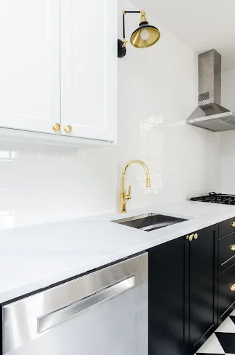 white quartz kitchen with golden tap
